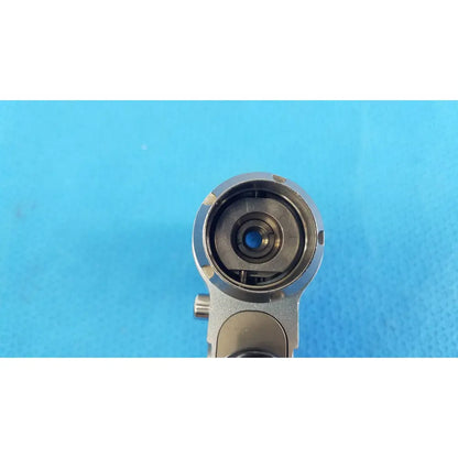 Silver-toned metallic camera lens with blue-tinted glass on stryker cd4 cordless driver universal handpiece dual trigger