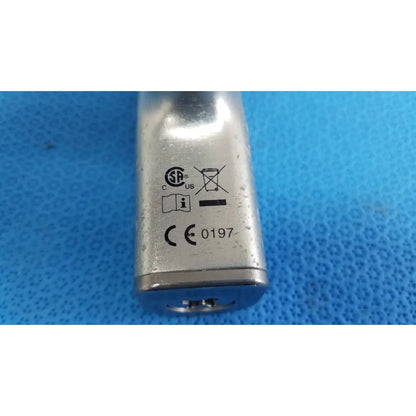 Silver cylindrical metal stryker cd4 cordless driver universal handpiece with dual trigger and model number 0197 embossed