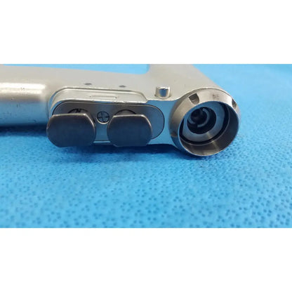 Silver surgical drill with black ergonomic grips and circular chuck mechanism in stryker cd4 cordless driver universal handpiece