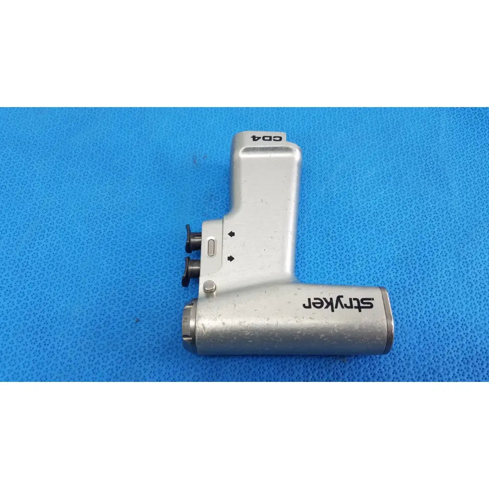 Silver stryker cd4 cordless driver universal handpiece with metallic ergonomic design and black branding for surgical use