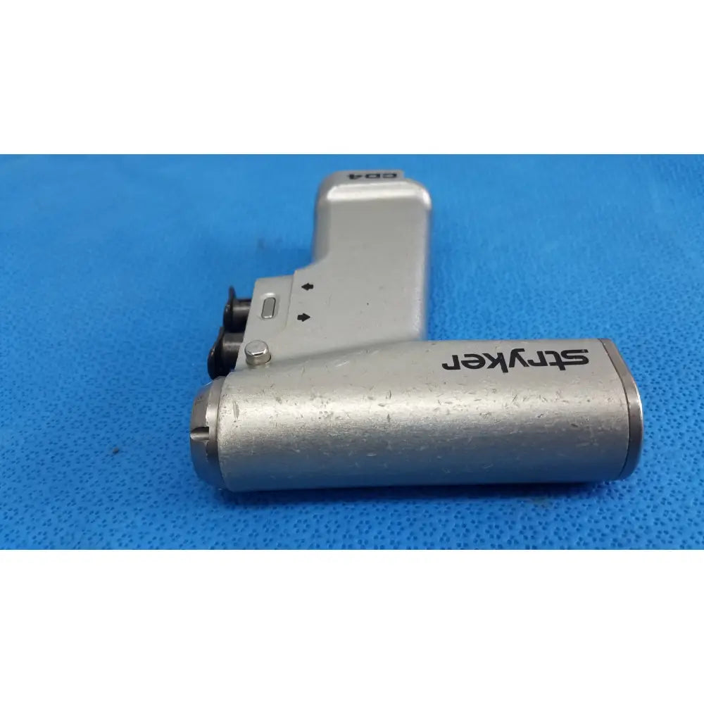 Silver stryker cd4 cordless driver universal handpiece with textured metallic finish and black branding dual trigger
