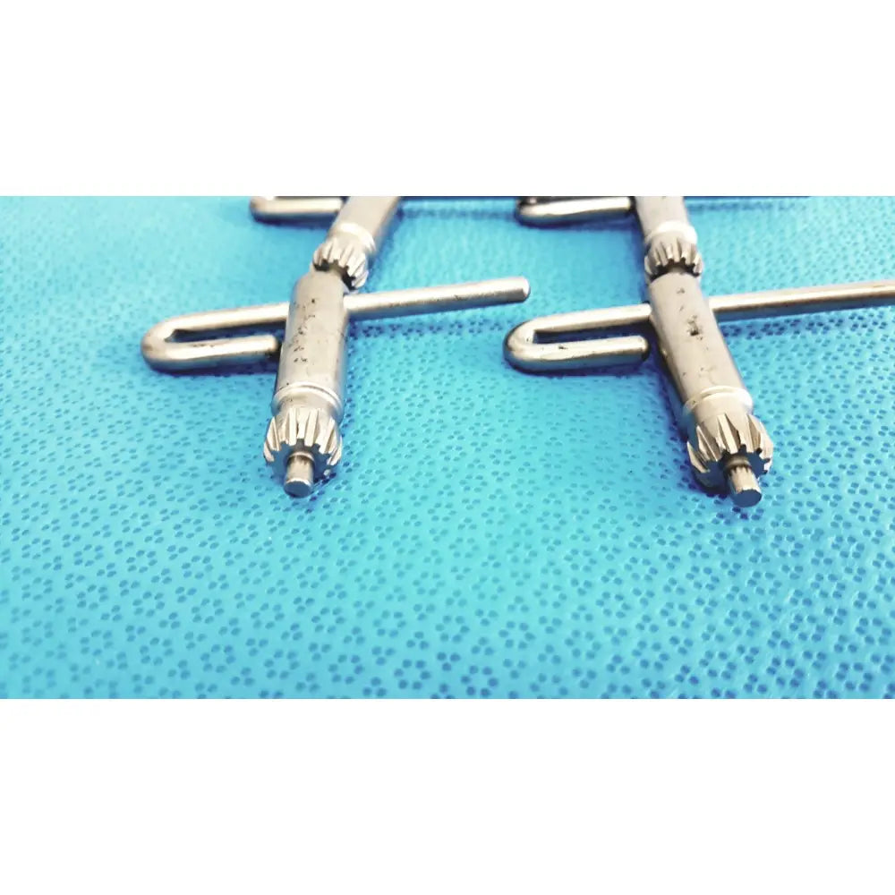 Silver surgical stryker chuck key screws with textured gear-like ends and cylindrical shafts for surgical drill systems lot 4