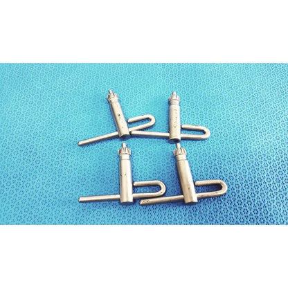 Four metallic silver stryker chuck keys with cylindrical body u-shaped handle and threaded top for surgical drills