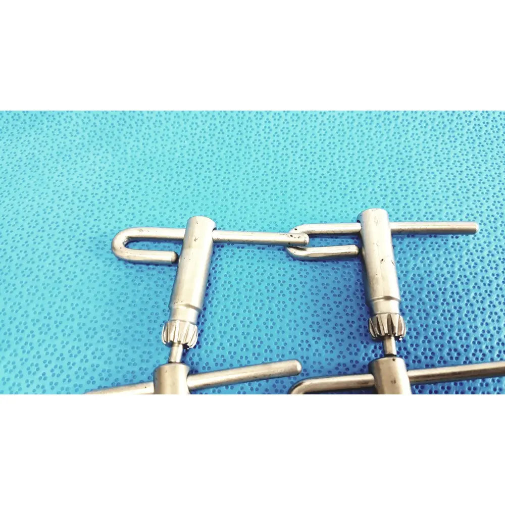 Stainless steel stryker chuck key handles with textured gear-like ends and u-shaped connecting links lot of 4