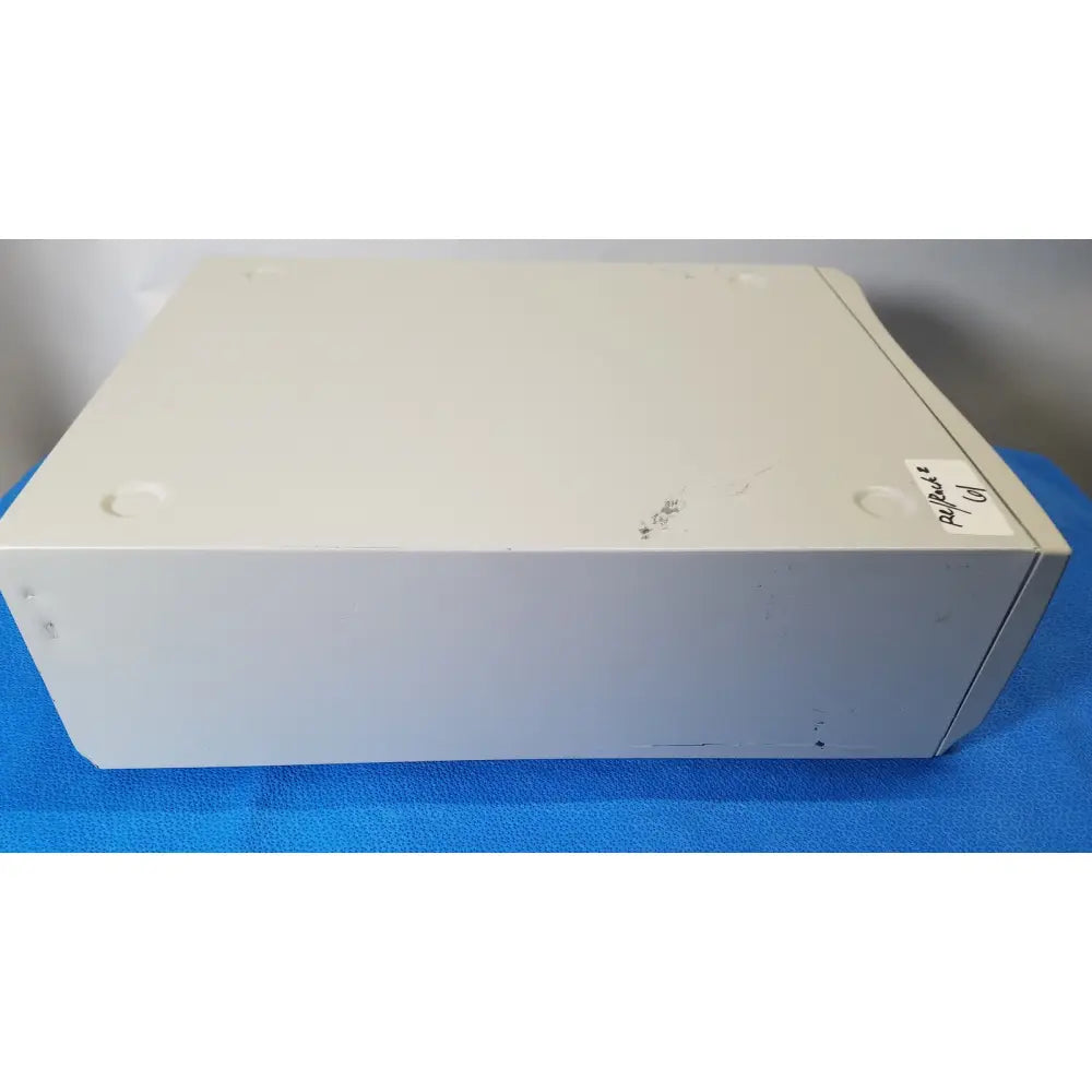 Off-white plastic stryker core powered instrument driver with rounded corners and four circular feet for stability