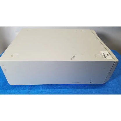 Off-white plastic stryker core powered instrument driver with rounded corners and four circular feet for stability