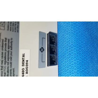 Blue textured fabric with a white label and gray port cover on a stryker core powered instrument driver ref 5400-050-000