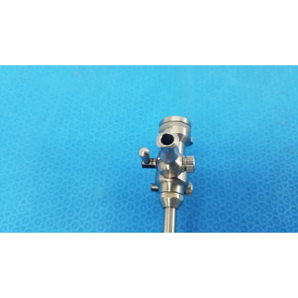 Silver stryker endoscopy 5.8mm surgical trocar with cylindrical body and knurled adjustment knobs for precision use