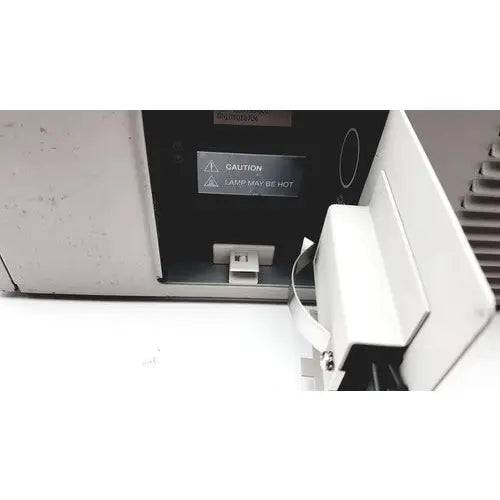 White plastic printer access panel with caution label for hot lamp on the back of stryker endoscopy x6000 light source