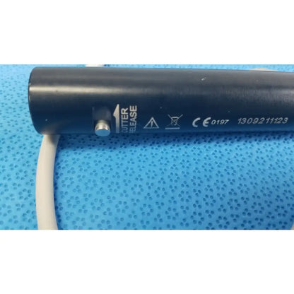 Black cylindrical stryker essx microdebrider handpiece with silver release button and white cable for reuse medical equipment