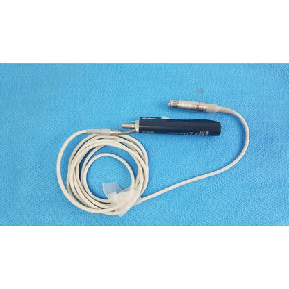 Black stryker essx microdebrider handpiece with coiled white cable and metallic connectors for reuse medical equipment