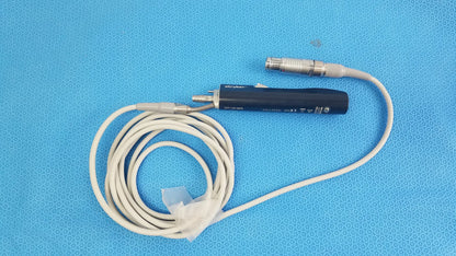 Black stryker essx microdebrider handpiece with coiled white cable and metallic connectors for reuse medical equipment