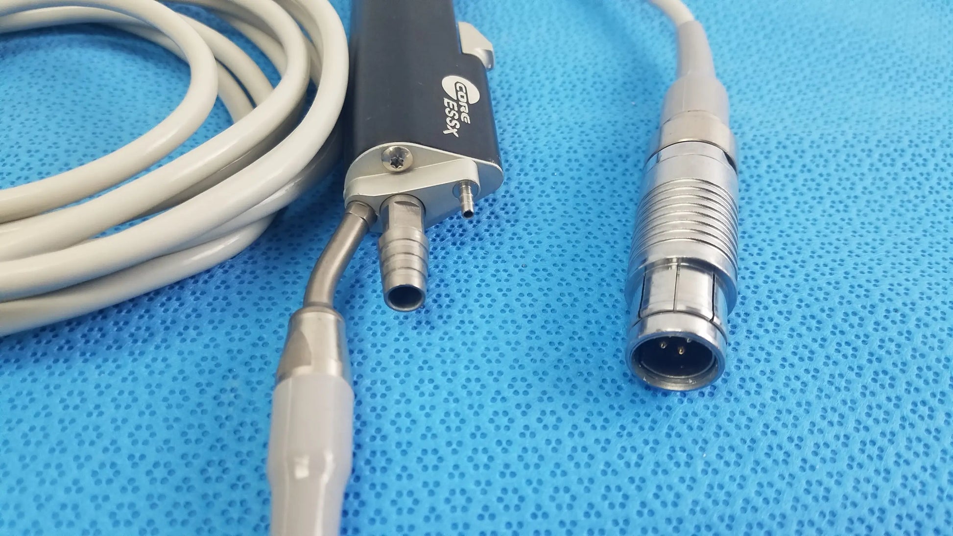 Black and silver Stryker ESSx microdebrider handpiece with coiled gray cable medical equipment for reuse medical equipment