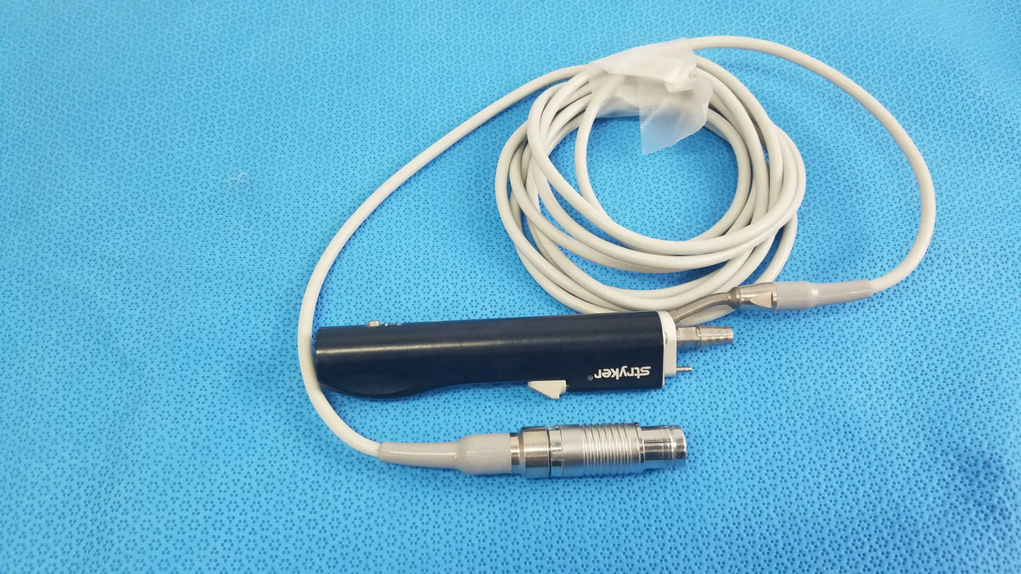 Black cylindrical Stryker ESSx microdebrider handpiece with silver connector and coiled white cable for medical equipment reuse