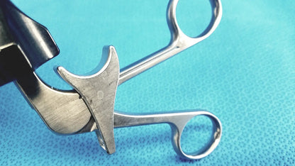 Silver surgical forceps with curved design and polished finish in stryker fenestrrated delicate grasper product