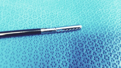 Silver stryker fenestrrated delicate grasper with black handle and serrated tip for precision surgical use