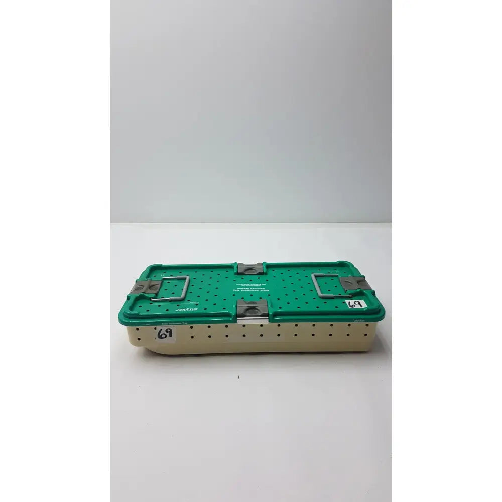 Green and beige metal stryker gamma3 optional instrument set tray with perforated sides and sturdy metal latches