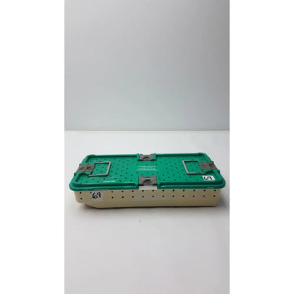 Green and beige metal stryker gamma3 optional instrument set tray with perforated sides and sturdy metal latches