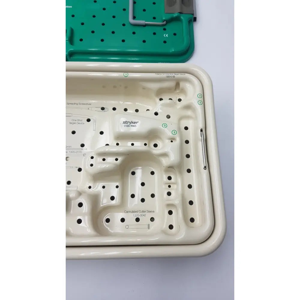 Cream-colored plastic stryker gamma3 optional instrument set tray with molded compartments and branded lid for surgical use