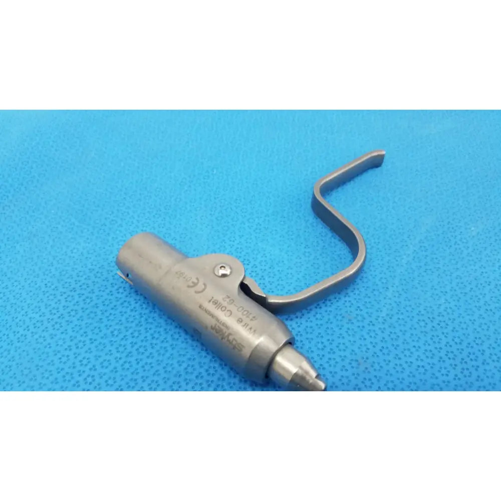 Silver metal wire collet attachment with curved handle and engraved stryker instruments marking model 4100-62