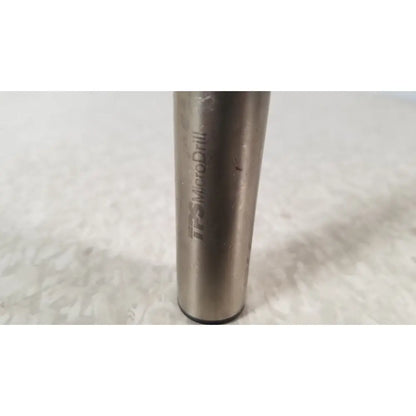 A metallic cylindrical handswitch tps microdrill bit with brushed finish and engraved stryker instruments handswitch branding