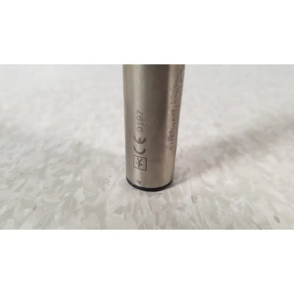 Silver cylindrical metal battery with engraved markings and black base for stryker instruments handswitch tps microdrill