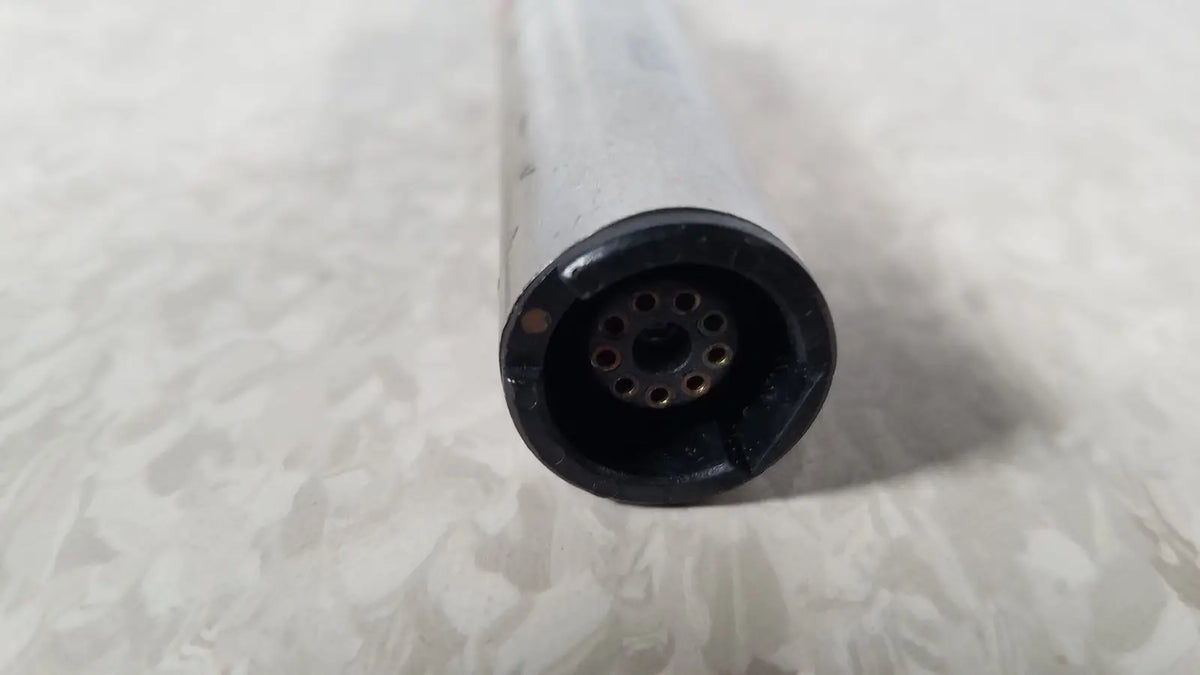 Black circular connector with multiple holes attached to translucent body of stryker instruments handswitch tps microdrill