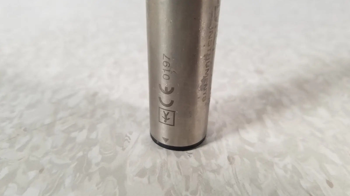 Silver cylindrical metal battery with engraved markings and black base for stryker instruments handswitch tps microdrill