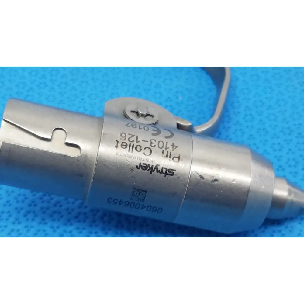 Stryker instruments pin collet 4103-126 is a metallic surgical instrument with engraved markings and a curved handle