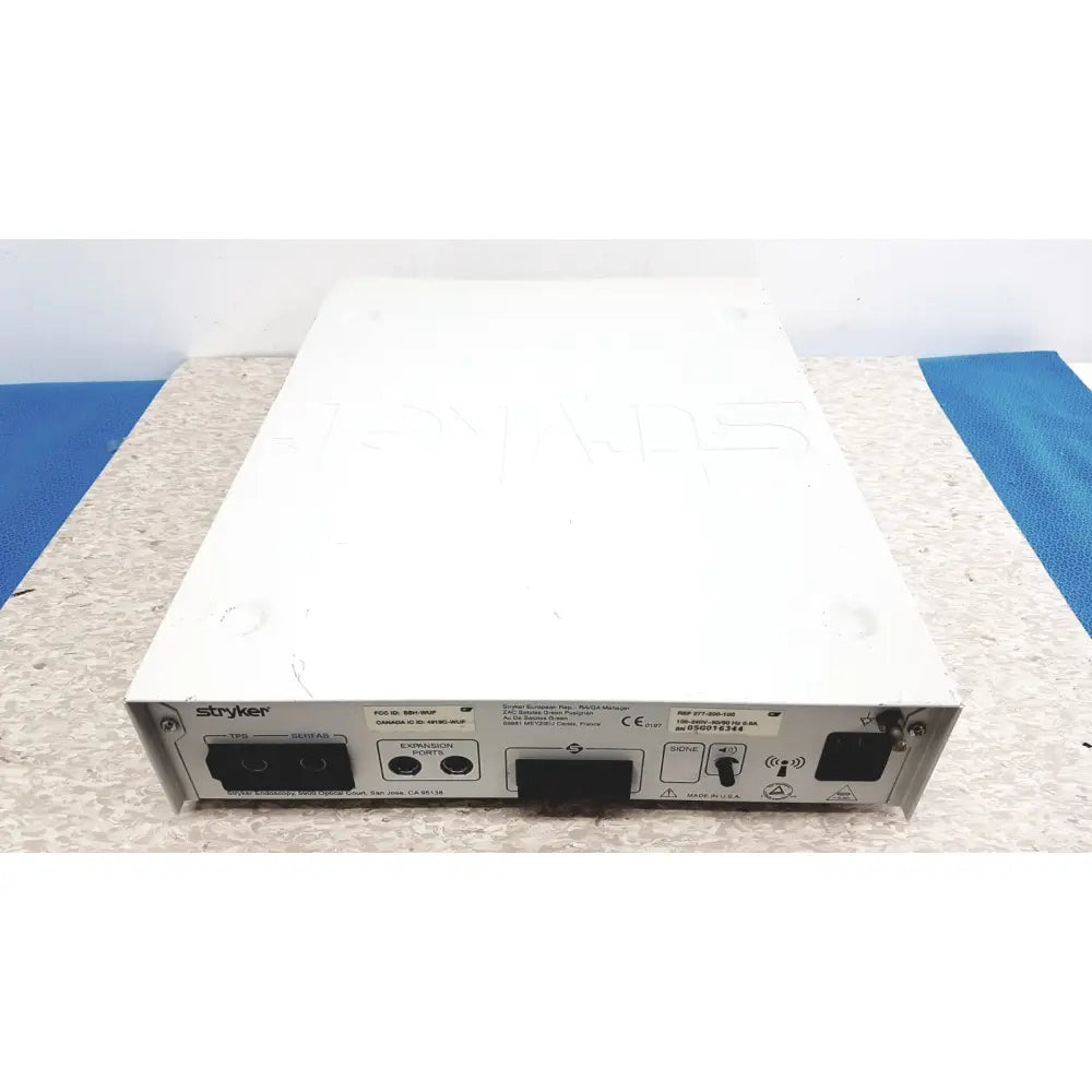 White rectangular stryker iswitch wireless universal foot control pedal showing multiple ports on rear panel