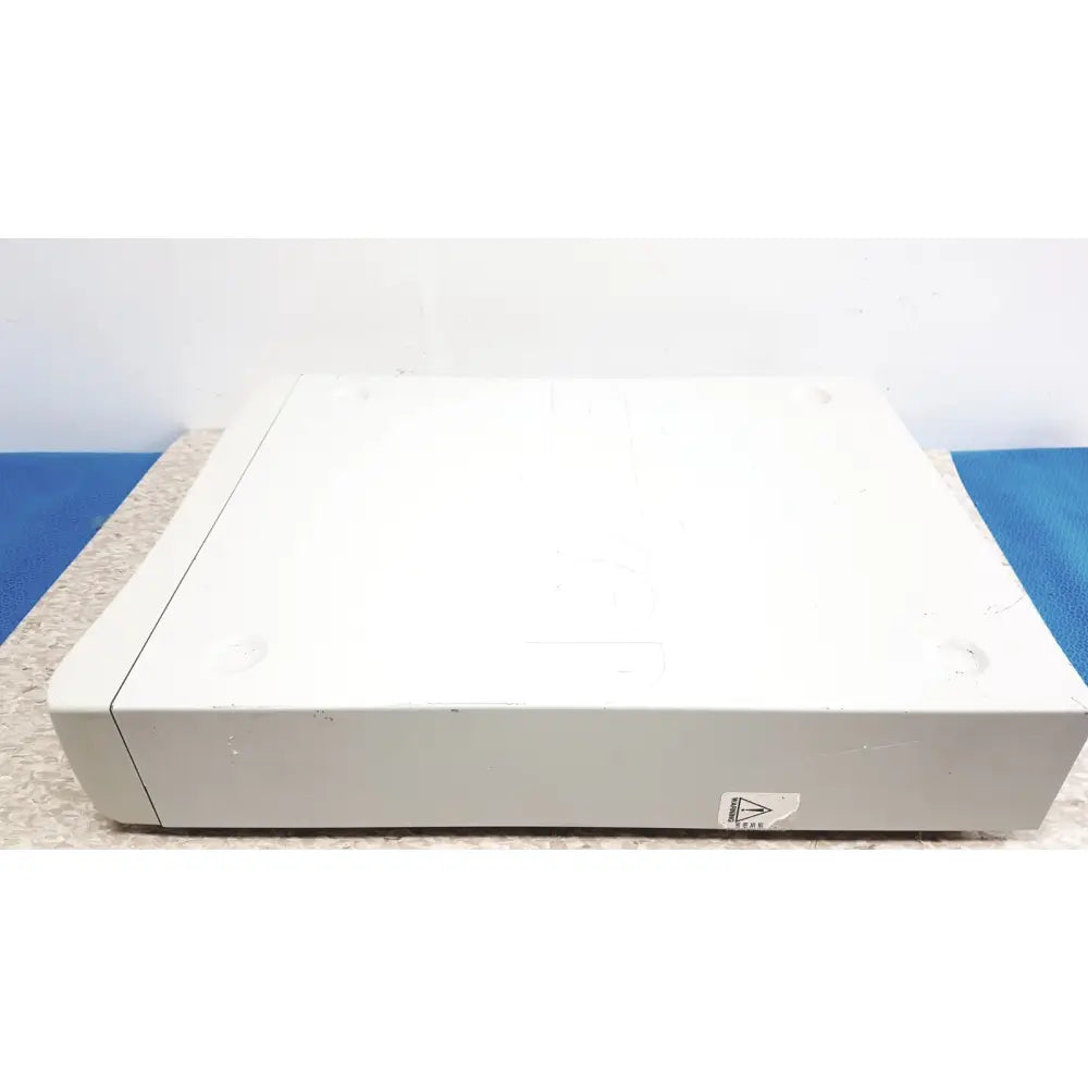 White plastic stryker iswitch wireless universal foot control pedal with rounded edges and a triangular sticker on front side