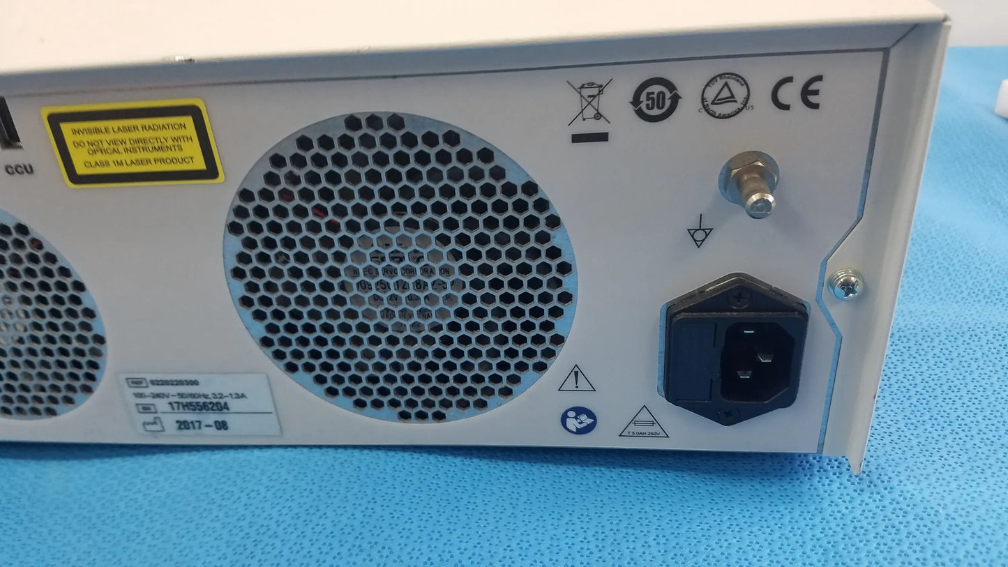 Back side of white industrial-grade power supply unit with hexagonal ventilation for stryker l10 led light source aim advanced imaging modality