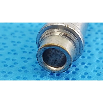 Silver metallic cylindrical stryker light post adapter with threaded interior and wear marks for storz and olympus cables