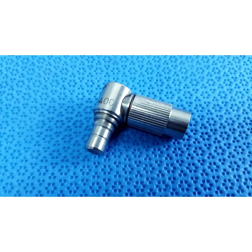 Silver metallic 90-degree right-angle stryker lot autoclavable 10mm 134ºc adapter with knurled grip and engraved 40c marking