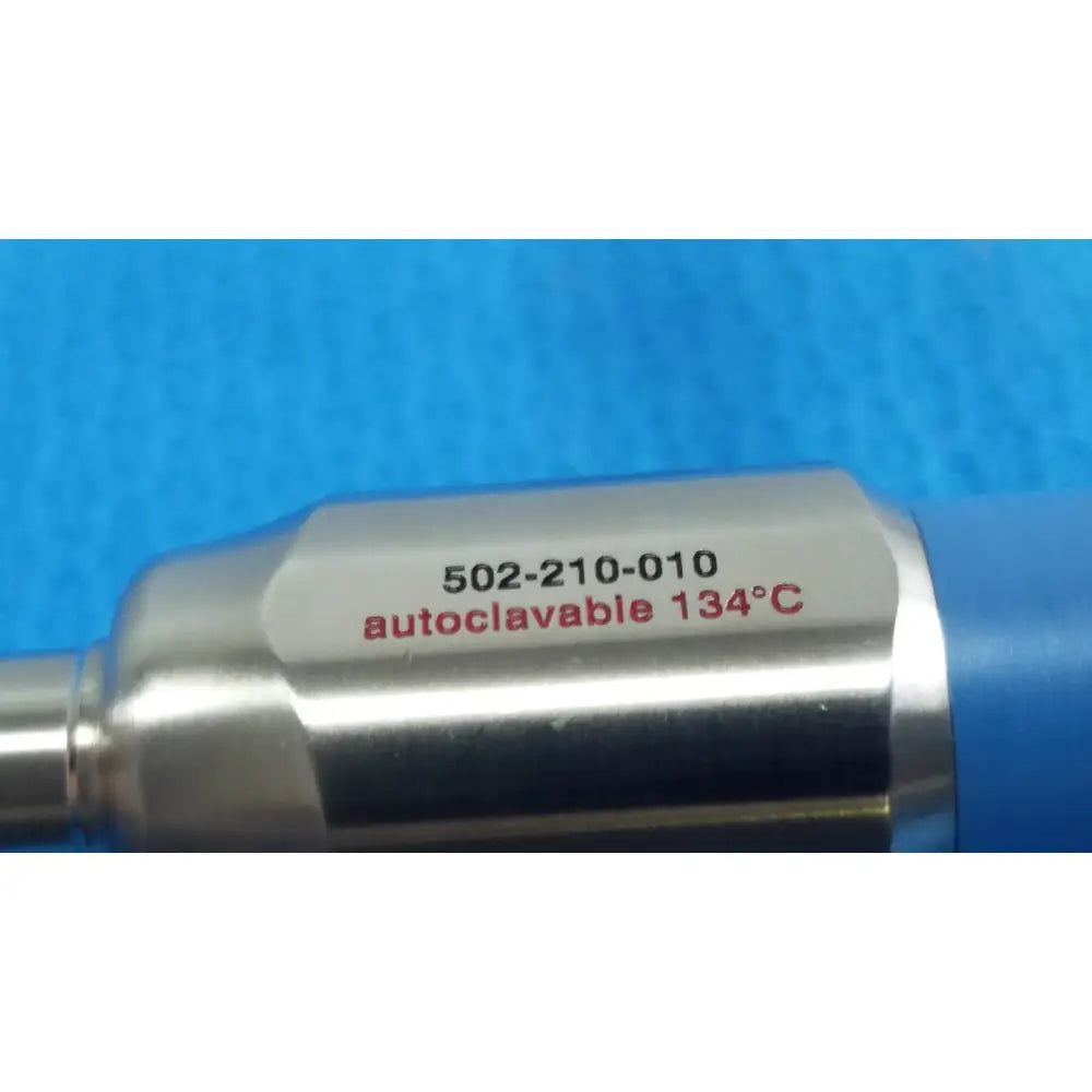 Silver metallic cylindrical stryker lot autoclavable 10mm 30º scope with engraved red text and sterilization tray