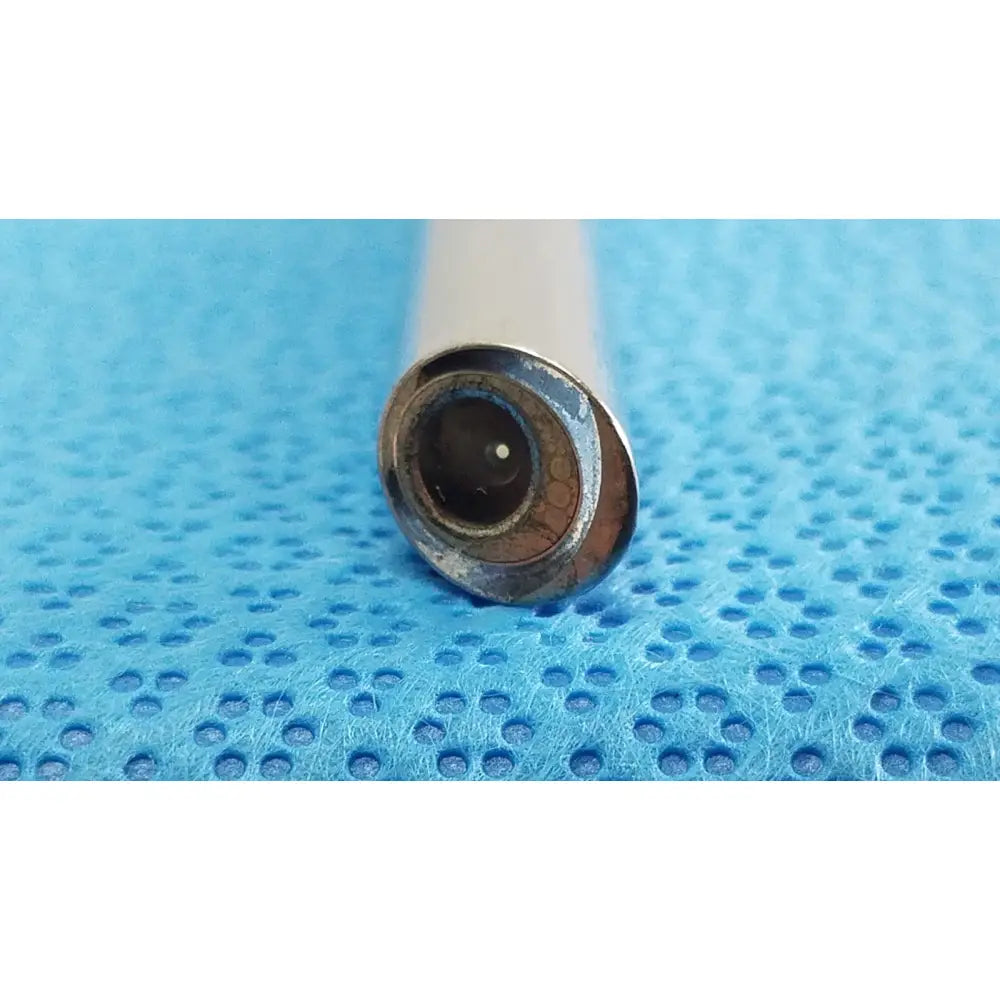 A close-up of a white cylindrical Stryker lot vape pen with autoclavable 134ºc scope and metallic mouthpiece