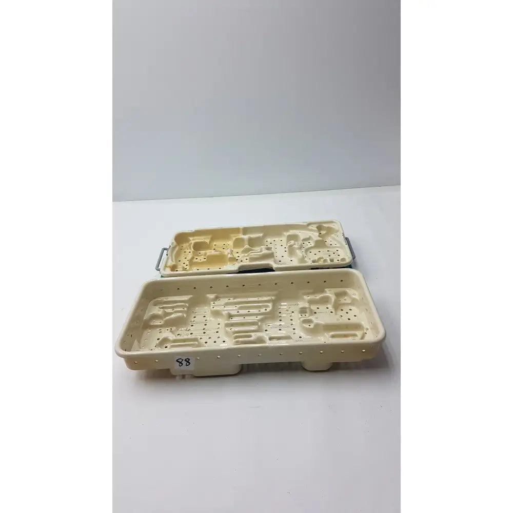 Cream-colored plastic stryker optional instrument tray with molded compartments and perforations for instrument ray gamma3 system