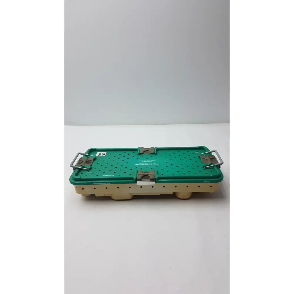 Green perforated surgical instrument tray with beige base and metallic latches for stryker optional instrument ray gamma3 system