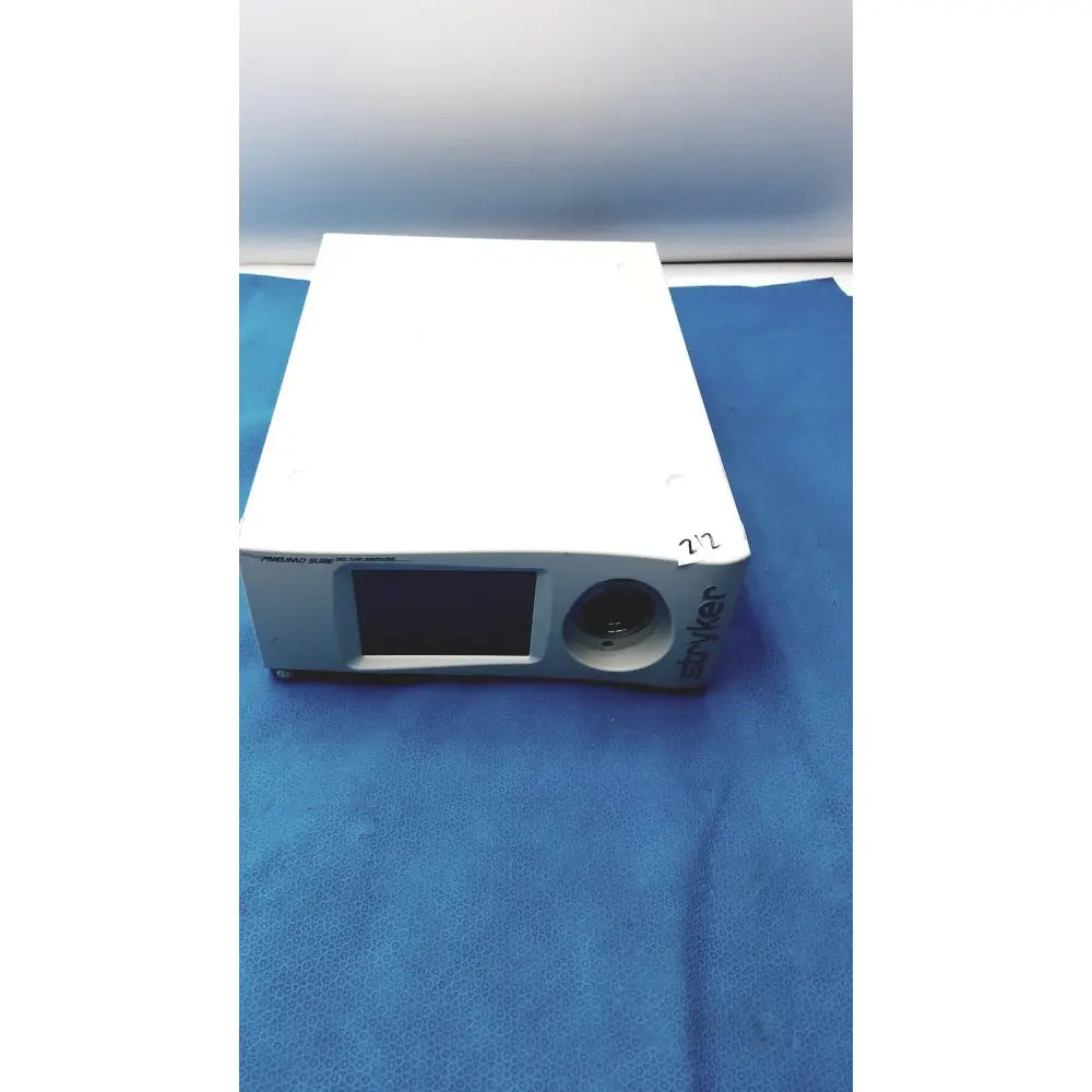 White rectangular stryker pneumo sure xl high flow insufflator with small screen and circular lens for medical use
