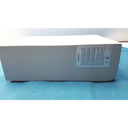 Beige rectangular electronic stryker pneumo high flow insufflator with white warning label on side for medical use