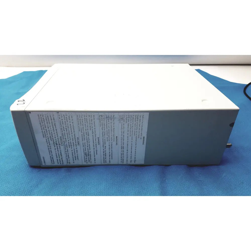 White rectangular stryker pneumo sure xl high flow insufflator with safety label on the side for medical use