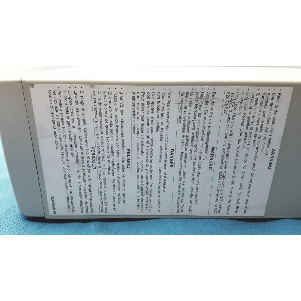 The back of a white plastic stryker pneumo high flow insufflator with multilingual safety warnings and instructions