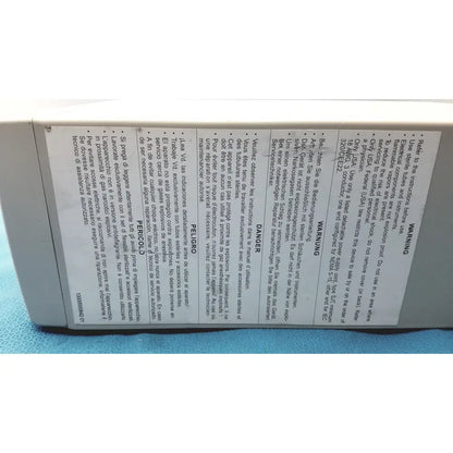 The back of a white plastic stryker pneumo high flow insufflator with multilingual safety warnings and instructions