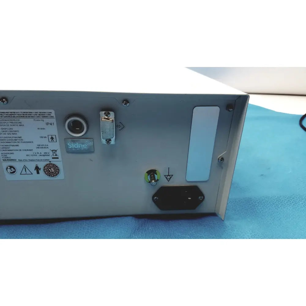 Back side of silver metallic stryker pneumo high flow insufflator power supply unit with multiple ports and bilingual labels