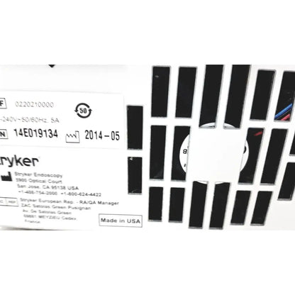 White stryker precision light source label with black text and ventilation slots on the back of surgical illumination unit