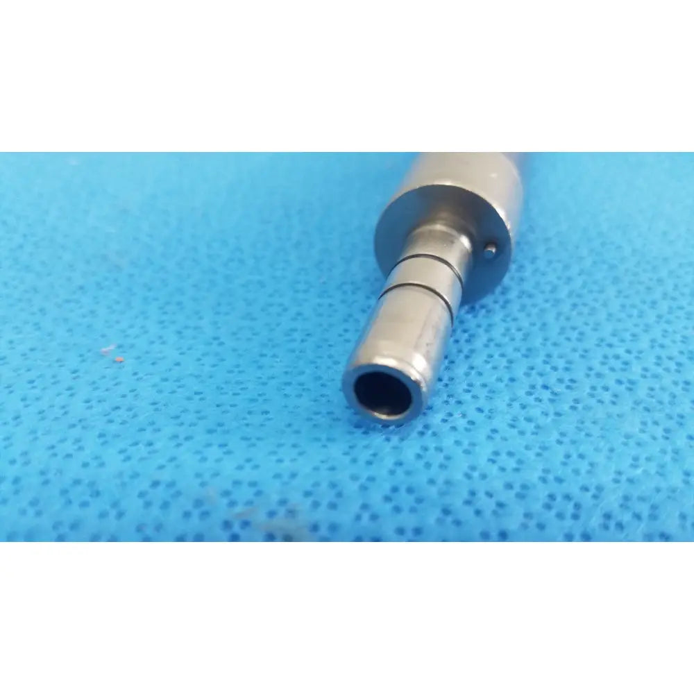 Silver metallic cylindrical stryker remb electric micro drill handpiece with threaded end and machined grooves