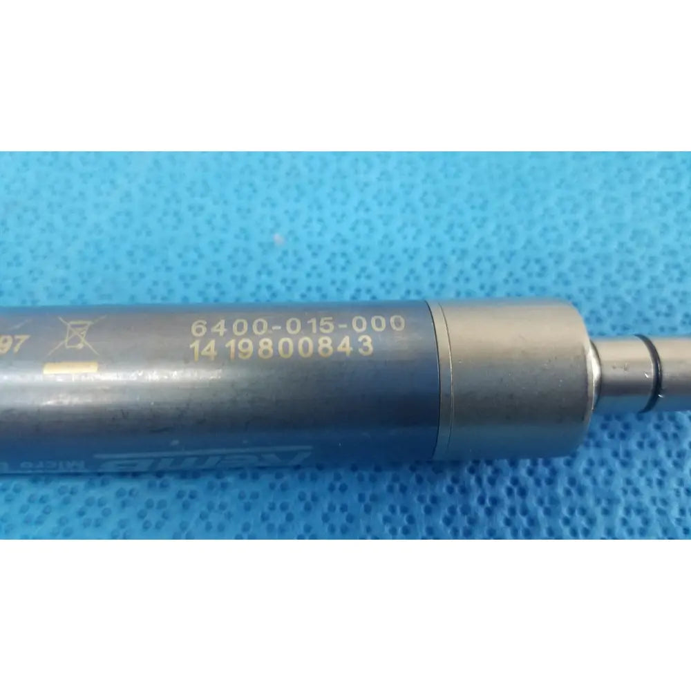 Gray metallic cylindrical stryker remb electric micro drill handpiece with engraved serial numbers and shur logo