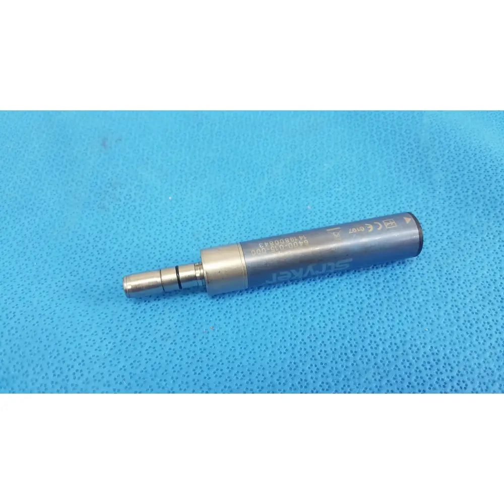 Silver-colored metallic stryker remb electric micro drill handpiece with engraved markings and cylindrical body