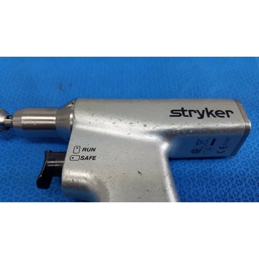 Stryker Sago 2 surgical orthopedic reciprocating saw power tool with silver metallic finish and black safety switch