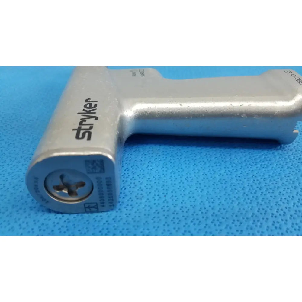 Silver-colored metal stryker sago 2 surgical orthopedic reciprocating saw with textured grip and engraved branding